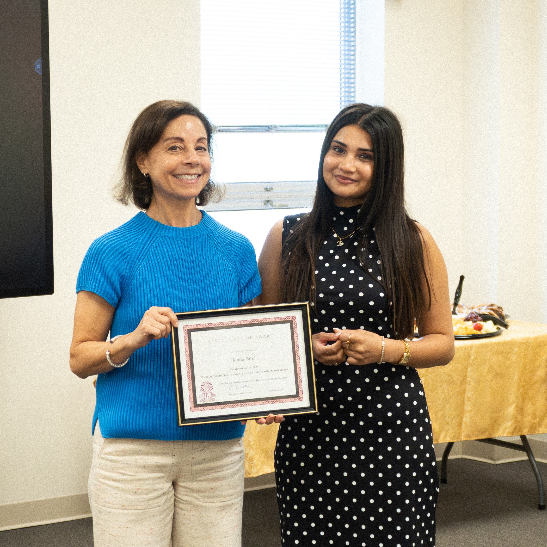 Dr. Cheri Shapiro presenting the 2025 Smith Scholarship to awardee Henna Patel.